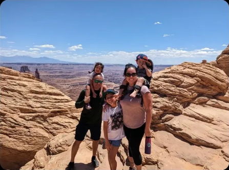 Jessica and her family on red rock formations at Canyonlands National Park, Utah