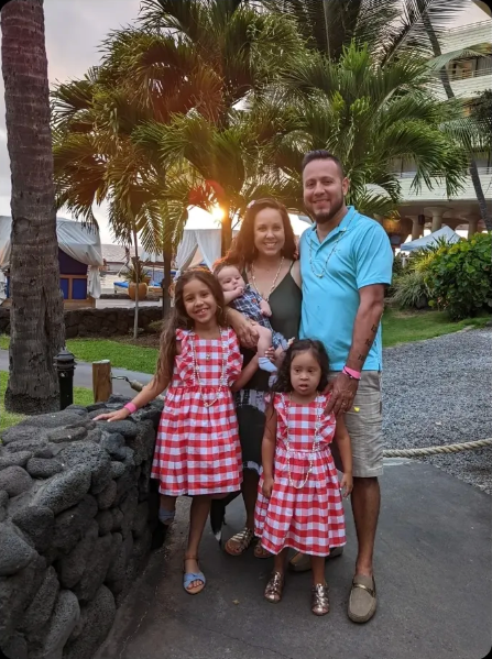 Jessica and her family among palm trees at sunset on the Island of Hawaii