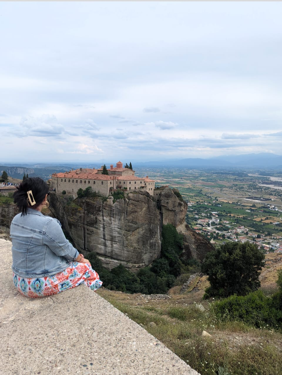 Jessica looking out at a clifftop monastery in Kalabaka, Greece
